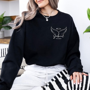 May include: Black sweatshirt with white angel wings and the name "Gabriel" with a date.