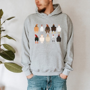 May include: A gray hooded sweatshirt with a print of various chickens in different colors and poses.