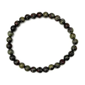 May include: A circular beaded bracelet composed of smooth, round stones in mottled shades of dark olive green, forest green, and deep reddish-brown. The beads are uniform in size and strung together on an elastic cord, forming a continuous loop.