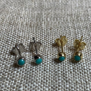 May include: Four pairs of stud earrings with turquoise-colored stones. Two pairs are silver-toned, and two are gold-toned. The earrings have a simple, minimalist design, perfect for everyday wear.