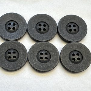 Black buttons 23mm with a soft sheen finish sold as a set of six buttons
