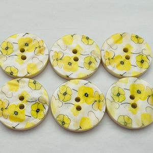 Flower print buttons 23mm yellow on a white background with a pearly finish sold as a set of six buttons
