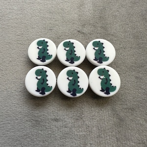 Dinosaur buttons green on a matt white background 14mm a set of 6