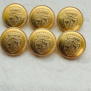 May include: Six gold-toned buttons featuring a raised design of a shield with a crown, eagle, and fleur-de-lis.