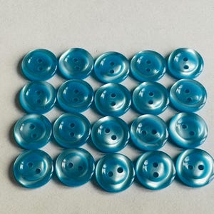 Bright blue buttons 15mm with a pearl finish, classic style sold as a set of twenty.