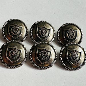 Metal button, 21mm, aged silver-tone, stylised Thistle design on a shank. Sold as a set of six buttons. For blazers, jackets, Celtic wear.