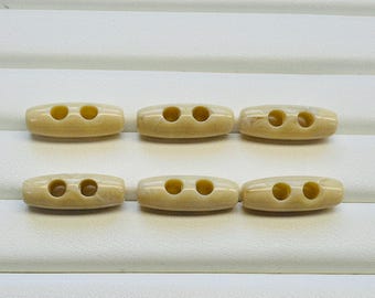 Cream toggles 25mm marbled finish, sew-through. A set of six