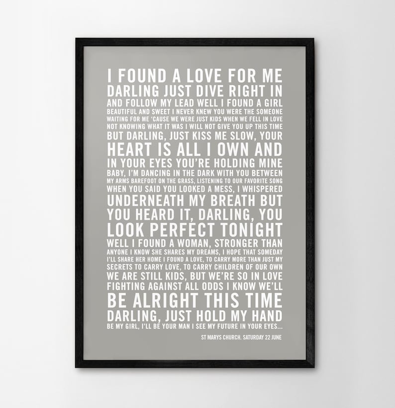 May include: A gray and white printable wedding sign with the lyrics to the song "I Found a Love for Me" by The Wedding Present. The text includes the lyrics, "I found a love for me, darling just dive right in and follow my lead..." and the date and location of the wedding, "St. Mary's Church, Saturday 22 June."