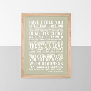 May include: A framed print with a light green background and white text. The text is a song lyric that reads "Have I told you lately that I love you..." The print is in a wooden frame.