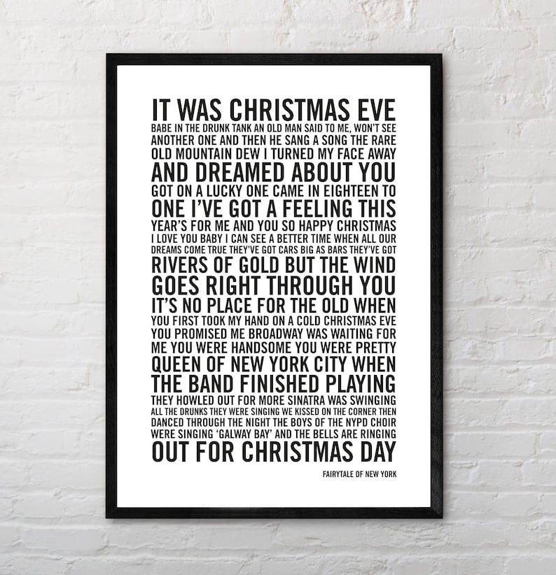 May include: Black and white printable wall art featuring the lyrics to the song "Fairytale of New York" by The Pogues and Kirsty MacColl. The lyrics are printed in a bold, sans-serif font.