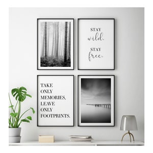 May include: Set of four black and white framed prints with inspirational quotes and nature photography. The prints feature a foggy forest, a quote about taking only memories and leaving only footprints, a quote about staying wild and free, and a black and white photo of a pier extending into a lake.