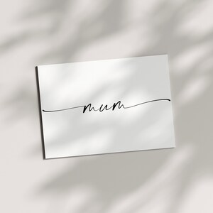 May include: A white card with the word "mum" written in black cursive script.