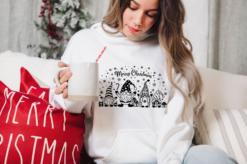 May include: White hooded sweatshirt with a black and white graphic of gnomes and the text "Merry Christmas".