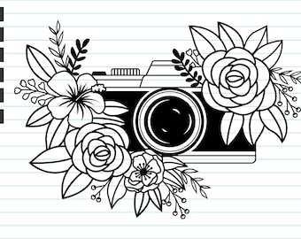May include: Black and white line art illustration of a vintage camera with a floral design. The camera is surrounded by flowers, including roses, hibiscus, and other floral elements.