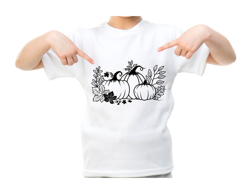 May include: A white t-shirt with a black and white illustration of three pumpkins with leaves and stems.