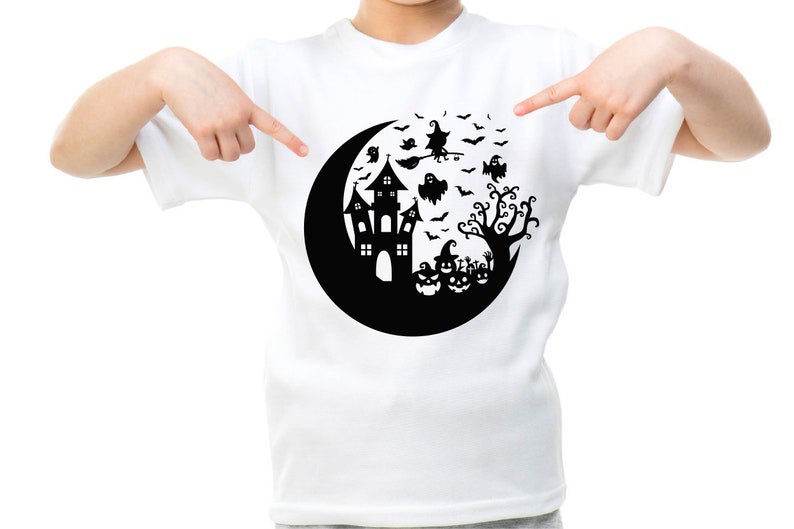 May include: White t-shirt with a black graphic of a crescent moon, a haunted house, a witch flying on a broomstick, bats, ghosts, and pumpkins.
