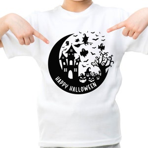 May include: White t-shirt with a black graphic of a crescent moon, a haunted house, a witch flying on a broomstick, bats, ghosts, and a tree. The text "Happy Halloween" is written around the moon.