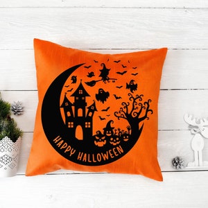 May include: Orange throw pillow with a black silhouette of a haunted house, a crescent moon, bats, ghosts, a witch flying on a broomstick, and a tree. The text "Happy Halloween" is written in a circle around the design.
