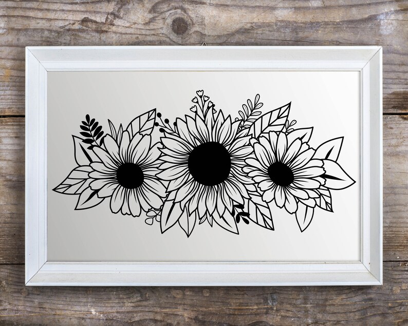 May include: A framed black and white floral print depicting three sunflowers with detailed petals and dark centres. The artwork is set against a light background within a white rectangular frame, suitable for home decor.