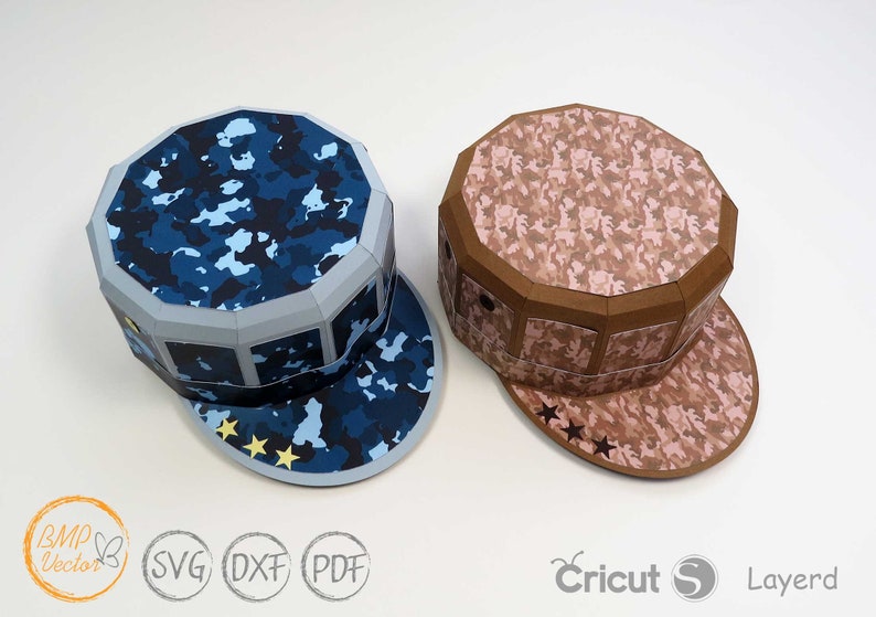 May include: Two papercraft hats with camouflage patterns. One hat is blue and the other is brown. Both hats have a star design on the brim.