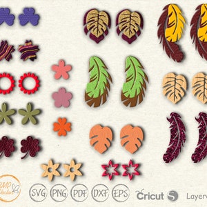 Op de afbeelding: Een set van 20 oorknopdesigns met verschillende vormen, kleuren en patronen. De ontwerpen omvatten bladeren, bloemen, veren, sterren en geometrische vormen. De oorknoppen zijn gemaakt van hout, leer en glitter.