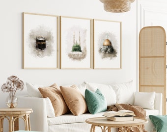 May include: Three framed watercolour paintings of Islamic architecture. The paintings are hung on a white wall above a white sofa with brown throw cushions and a green throw cushion. A wooden coffee table sits in front of the sofa.