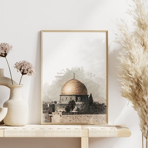 May include: A watercolor print of the Dome of the Rock in Jerusalem, a golden dome with intricate details, set against a light gray background with watercolor splatter effects.