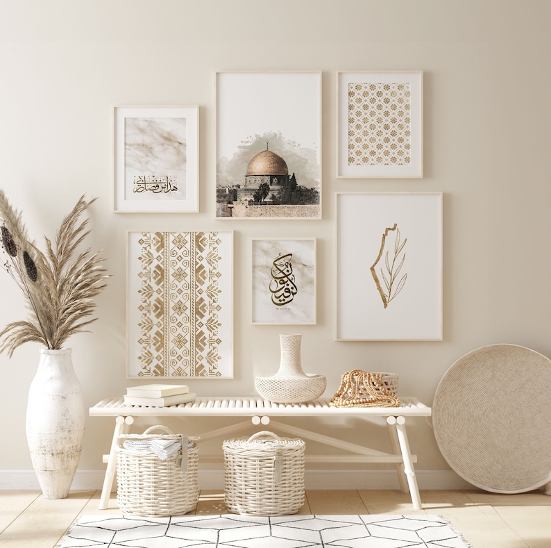 May include: A white wooden bench with two white wicker baskets underneath. The bench is decorated with a gold-colored vase, a beaded garland, and a woven tray. There are six framed prints on the wall behind the bench, featuring a mosque, geometric patterns, and Arabic calligraphy.