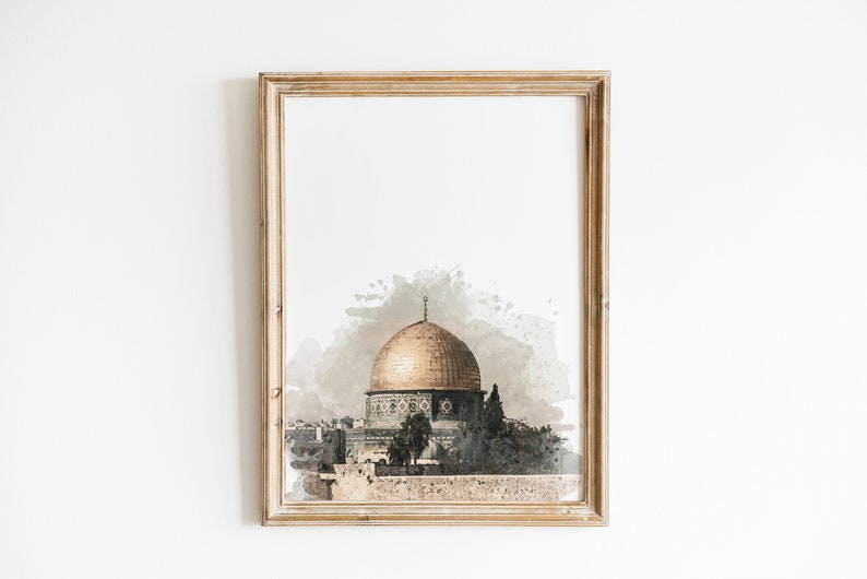 May include: A framed watercolor painting of the Dome of the Rock in Jerusalem. The dome is gold and the building is green and white. The painting is set against a light brown background.
