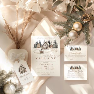May include: A baby shower invitation suite with a watercolor village scene, including an invitation, thank you tag, and raffle cards. The invitation features the text "It takes a Village". The color palette is soft and neutral with wintery accents.