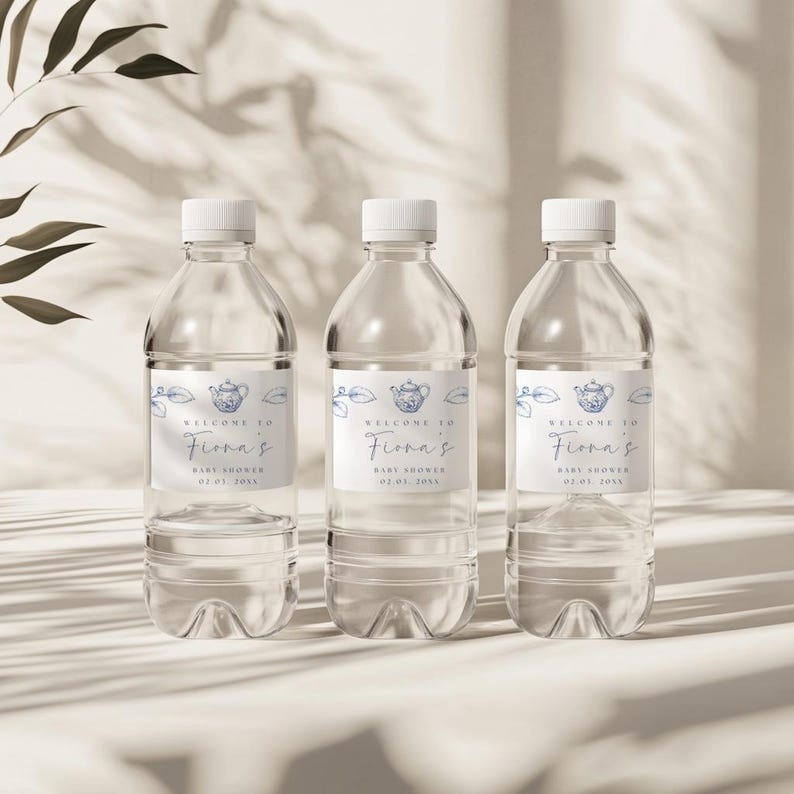 May include: Three clear plastic water bottles with blue and white labels that say "Welcome to Fiona's Baby Shower 02.02.20XX".
