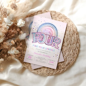 May include: Pink birthday invitation with the word "FOUR" in a glittery font. The invitation includes the text "Find Your Sparkle" and details for Amanda's birthday, including the date, time, and location. The invitation is on a woven mat.