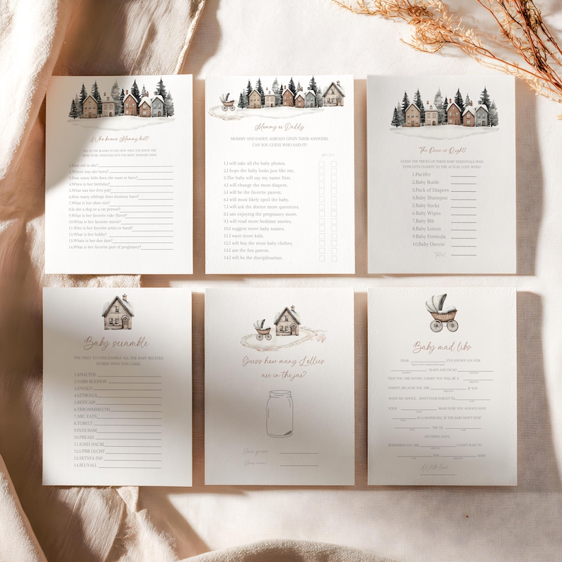 May include: Six cream-colored baby shower game cards with watercolor illustrations of houses and trees. The cards include games like "Baby Scramble" and "Guess how many jellies are in the jar?"