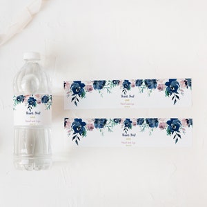 May include: Two water bottle labels with a watercolor floral design in shades of blue and pink. The labels say "Thank You!" with the text "Love" and the names "Daniel and Liga".