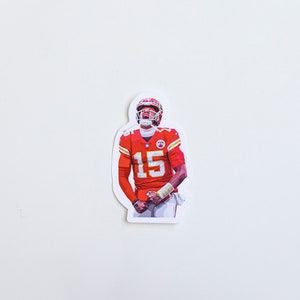 May include: A sticker featuring a football player wearing a red and white jersey with the number 15. The player is wearing a helmet and is in a celebratory pose.