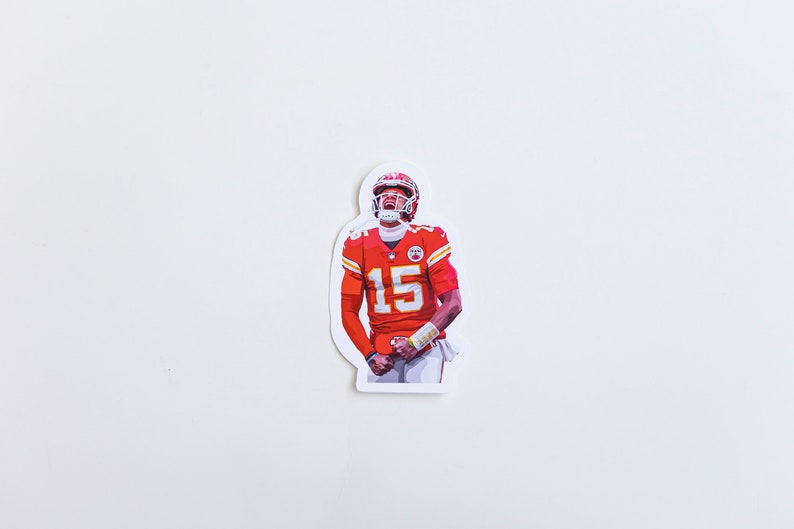 May include: A sticker featuring a football player wearing a red and white jersey with the number 15. The player is wearing a helmet and is in a celebratory pose.