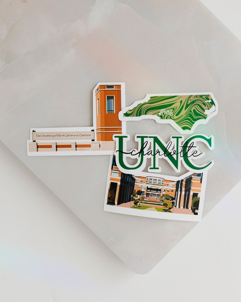 May include: A set of four stickers featuring the University of North Carolina at Charlotte. The stickers include a green and white marbled outline of North Carolina, a green and white "UNC Charlotte" logo, a building with a clock tower, and a photo of a building with a courtyard.