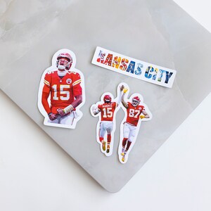May include: Three stickers featuring images of American football players wearing red and white uniforms. The stickers feature the numbers 15 and 87. One sticker has the text "KANSAS CITY" in colorful letters.