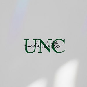 May include: A white sticker with green lettering that reads "UNC charlotte" in a cursive font.