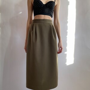 May include: A brown midi skirt with a high waist and a straight silhouette.