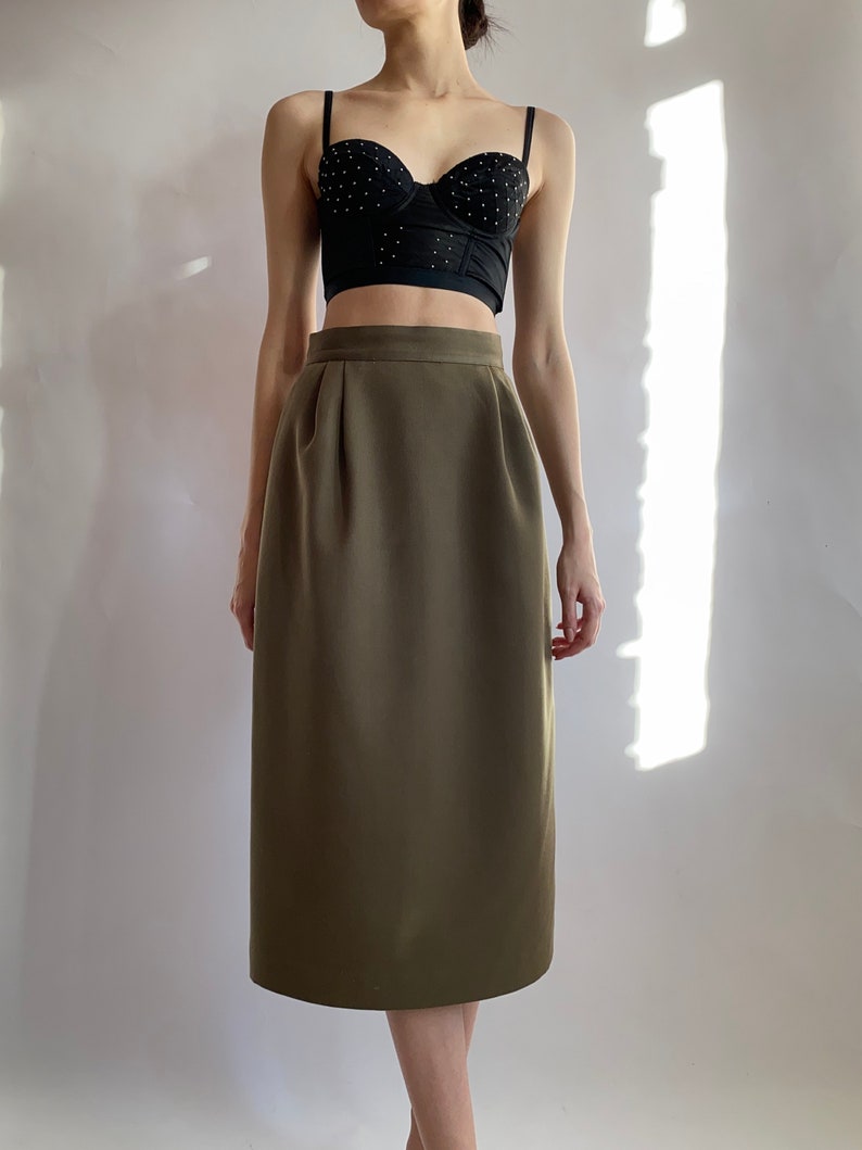 May include: A brown midi skirt with a high waist and a straight silhouette.