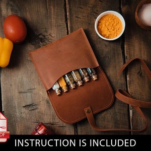 May include: A brown leather spice rack with a strap. The rack is open and contains six small glass jars filled with spices. The jars have cork tops.  INSTRUCTION IS INCLUDED.