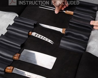 May include: Black leather knife roll with multiple slots for knives and tools. The roll is open and shows a variety of knives, including a cheese knife, a chef's knife, and a paring knife. The roll is labeled "INSTRUCTION IS INCLUDED".