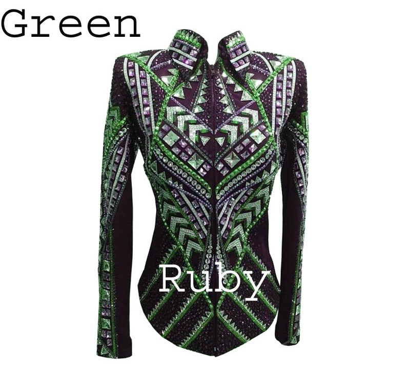May include: A long-sleeved jacket in deep purple featuring a high collar and a front zipper. The garment is heavily embellished with geometric patterns of green and clear crystals, sequins, and studs. The text Green and Ruby appears on the image.