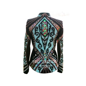 May include: A black and light blue long-sleeve jacket featuring intricate black scrollwork patterns, a high collar, and dense embellishments of iridescent crystals. The text RUBY FASHION STORE is printed in white on the lower front of the garment.
