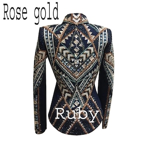 May include: A dark navy blue jacket featuring intricate geometric patterns embellished with numerous crystals and metallic studs in shades of rose gold and silver. The text "Rose gold" and "Ruby" is printed on the image.