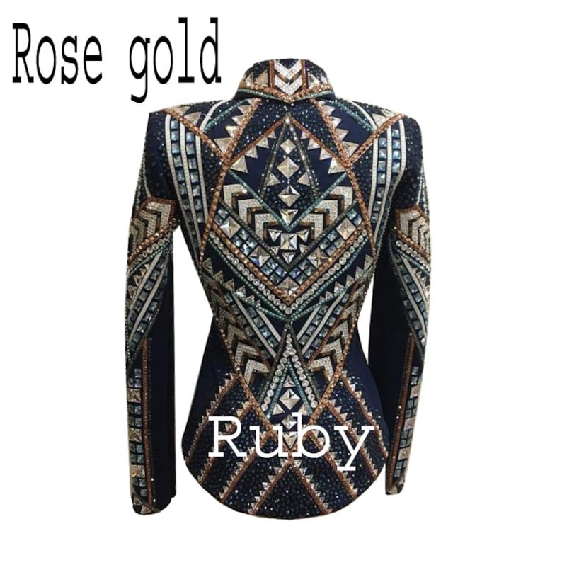 May include: A dark navy blue jacket featuring intricate geometric patterns embellished with numerous crystals and metallic studs in shades of rose gold and silver. The text "Rose gold" and "Ruby" is printed on the image.