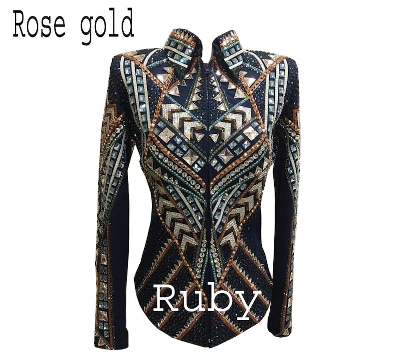 May include: A dark navy blue long-sleeve jacket featuring a high collar and a full-length front zipper. The garment is heavily embellished with geometric patterns of rose gold, silver, and clear crystals, rhinestones, and metallic studs.