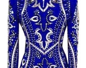 May include: A royal blue long-sleeve shirt featuring a high collar and a front zipper. The garment is heavily embellished with intricate silver and white patterns and numerous clear crystals arranged in symmetrical designs across the front and sleeves.