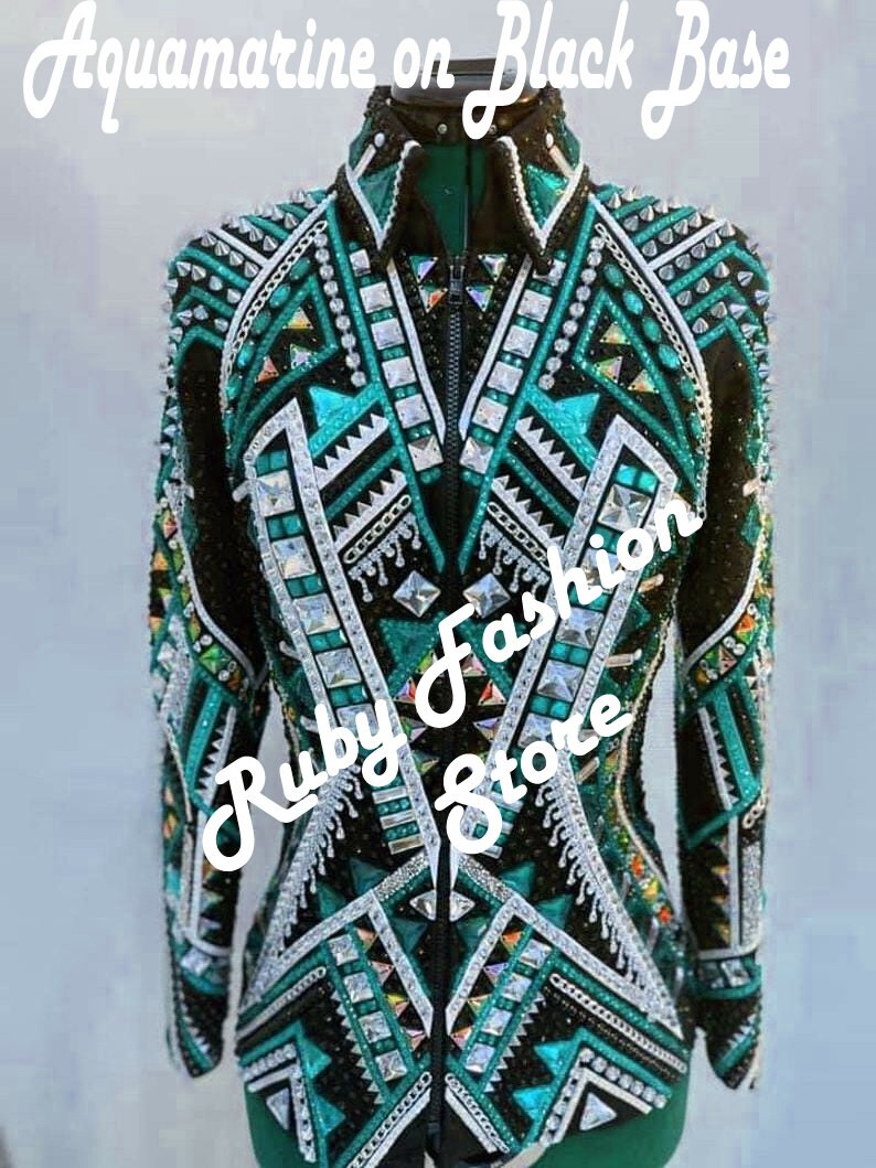 May include: A black long-sleeve jacket featuring intricate aquamarine and silver geometric patterns, embellished with numerous clear crystals and studs. The text "Aquamarine on Black Base" and "Ruby Fashion Store" is overlaid on the image.